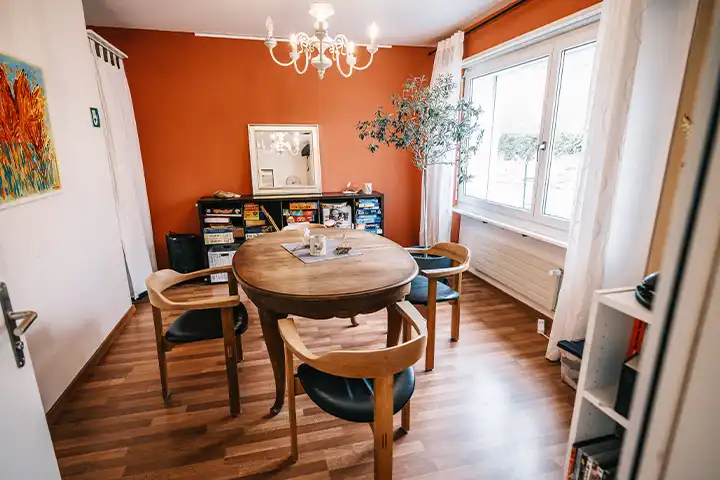 gemütliches Wohnzimmer mit antikem Holztisch in der Mitte